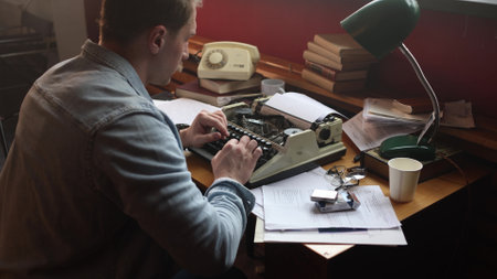 Cinematic portrait of pensive writer in vintage office, soft focus on typewriter and smoke-filled workspace.の写真素材