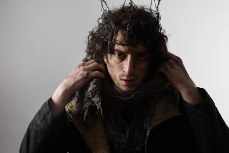 Hamlet in modern grunge or post-apocalyptic reinterpretation, young man, tragic Shakespearean hero in a crown of wireの写真素材