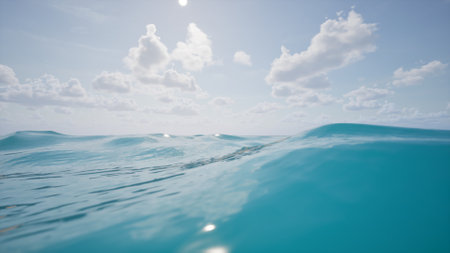 A minimalistic ocean landscape with calm waves, clear water, and a serene horizon. White clouds in the sky enhance the peaceful, natural beauty, perfect for summer, travel, or design projects.の写真素材