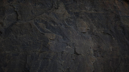A textured stone background with a brutal, monolithic rock formation, cracks, and fragments. Perfect for design templates or banners, showcasing raw power and natural beauty.の写真素材