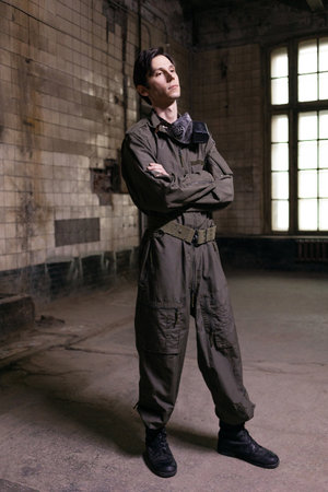 Military-clad man in gas mask, grunge portrait with tactical gear in post-apocalyptic environment.の写真素材