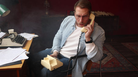Author in cinematic vintage office, on phone with typewriter and papers in soft-focus composition.の写真素材