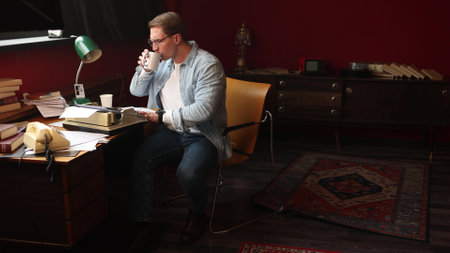 Cinematic portrait of pensive writer in vintage office, soft focus on typewriter and smoke-filled workspace.の写真素材