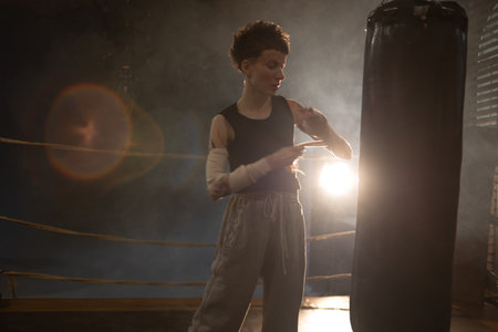 A moment of relaxation before new achievements,concept, sporting achievements, female wrestler in the boxing ring, cinematic look, mood, motivational storiesの写真素材