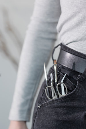 Manicure tools in jeans pocket, playful concept of a passionate nail technicians everyday essentials.の写真素材