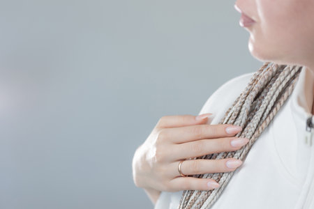 Stylish manicured hand with white braids, close-up beauty and hair inspirationの写真素材