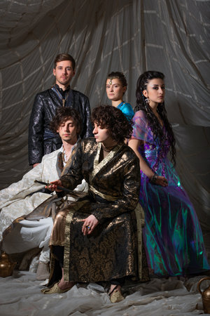 Middle Eastern fairytale group shot, models in luxurious Arabic attire against exotic backdrop