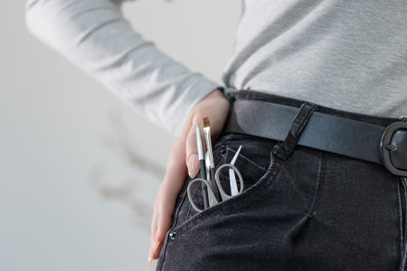 Manicure tools in jeans pocket, playful concept of a passionate nail technicians everyday essentials.の写真素材