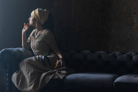 Dark fantasy heroine: gypsy witch in elaborate vintage clothing, intense gazeの写真素材