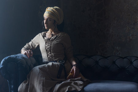 Mystical woman in gypsy witch attire, medieval-inspired costume with dramatic flair.