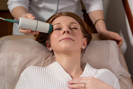 Spa treatment: microcurrent device used on womans face for tightening and toning effect