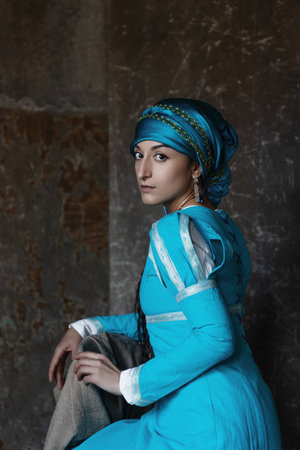 A bright and beautiful woman in a medieval-style costume, a black-haired girl in a bright blue dress...