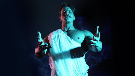 Young Zeus, an antique god in a white tunic against a background of lightning, a muscular man in a tunic, in the style of antique images or Renaissance paintingsの写真素材