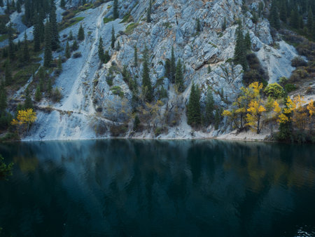Crystal-clear alpine lakes reflecting majestic mountain peaks, pristine wilderness panoramaの写真素材