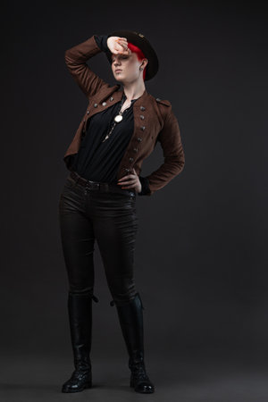 Red-haired lady in steampunk outfit featuring bowler hat with protective gogglesの写真素材