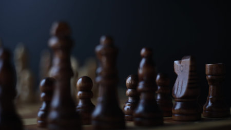 Chess, dynamic video of chess pieces on a rotating chessboard, the concept of confrontation between black and white. intellectual play, willingness to make the first moveの写真素材