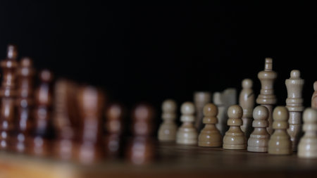 Animated sequence showing chess pieces on revolving board, capturing the essence of strategic decision-making and the black versus white dichotomy in chessの写真素材