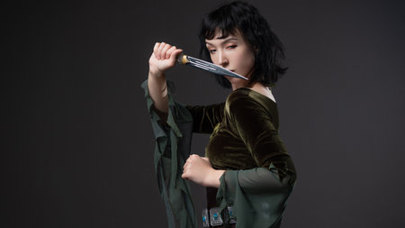 Brunette forest elf fighter in lightweight blouse with dagger belt, fantasy costumeの写真素材