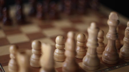 Chess, dynamic video of chess pieces on a rotating chessboard, the concept of confrontation between black and white. intellectual play, willingness to make the first moveの写真素材