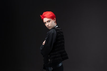 Woman with scarlet hair in pirate-style black suit and vest on dark gray