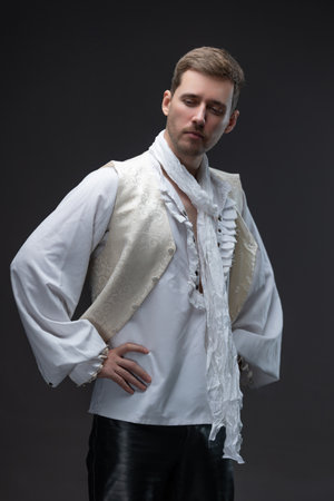 Baroque-era gentleman in white lace blouse and vest, decadent style on grayの写真素材
