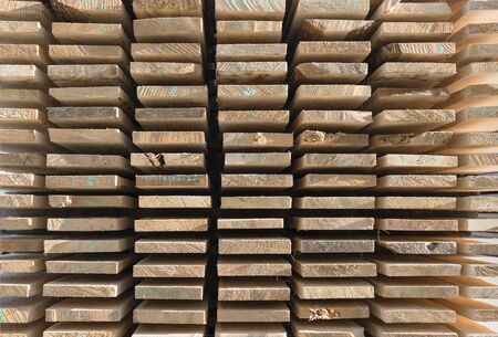 Piles of wooden boards in the sawmill, planking. Warehouse for sawing boards on a sawmill outdoors. Wood timber stack of wooden blanks construction material. Industry,textureのeditorial素材