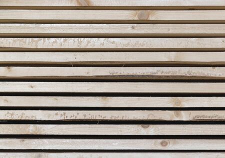 Piles of wooden boards in the sawmill, planking. Warehouse for sawing boards on a sawmill outdoors....