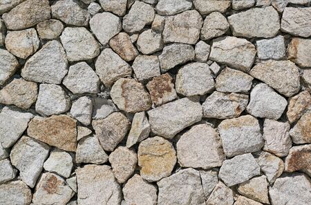 Texture of a stone wall. Old castle stone wall texture background. Part of a stone wall, for background or textureの写真素材