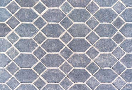 The texture of the paved tile on the bottom of the street. Cement brick squared stone floor...