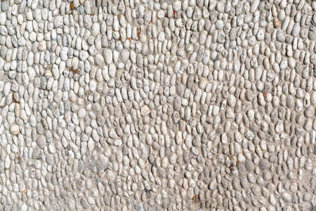 Sea Pebbles. Background of pebbles. Multi-colored pebbles. Wall and floor decoration. Sidewalk