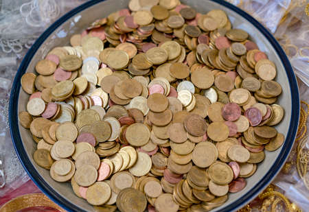 Gold, silver and bronze Thai coins for donation at Buddhist temple in Thailand.