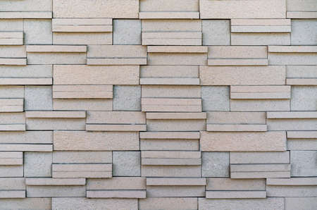 Stone cladding wall made of striped stacked slabs of natural brown rocks, panels for exteriorの写真素材