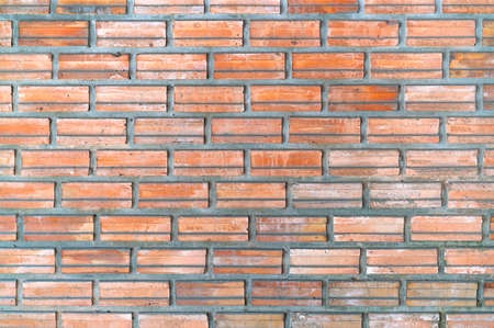 Old and aged red brick wall texture background with vignetting