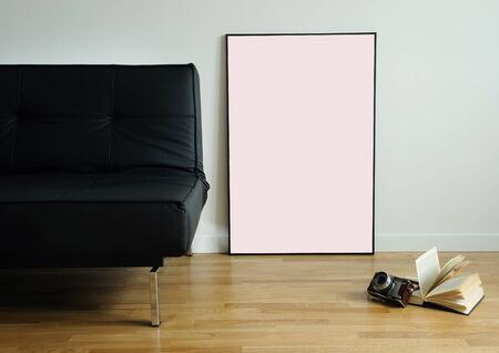 Empty frame on the parquet floor near the sofaの写真素材