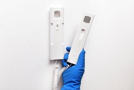 Disinfection in public places, the fight against the virus, coronavirus. The working hand wipes the...
