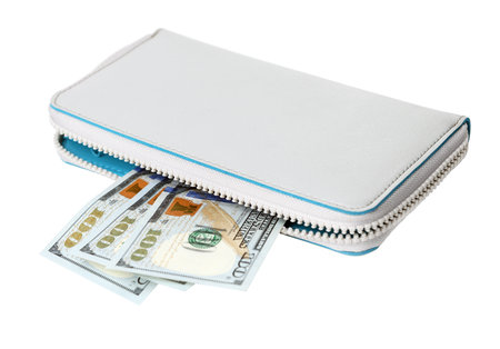 Wallet purse with US dollars.A hundred-dollar bill peeps out of the slit of the wallet.Female wallet isolated on a white background.の写真素材