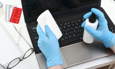 Disinfection in public places, the fight against the virus, coronavirus. A working hand wipes a...