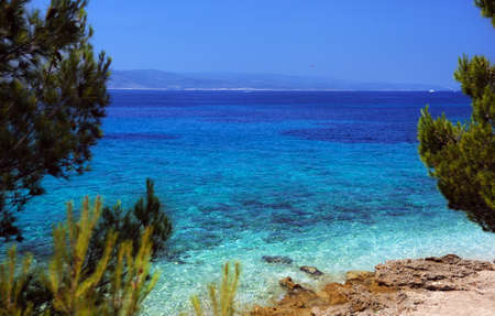 Beautiful view from the beach to the Adriatic Sea in Croatia, crystal clear turquoise water.