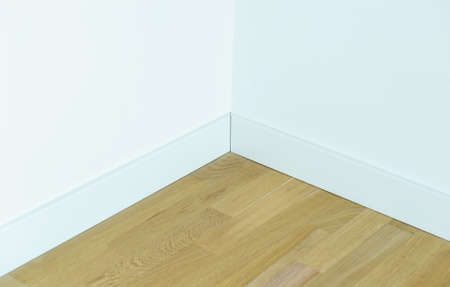 Parquet floor with a white wall, the corner of the roomの写真素材