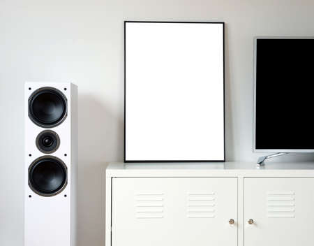 Poster Frame Mockup in white modern interior. Modern audio stereo system with white speakers on bureau in modern interior.の写真素材