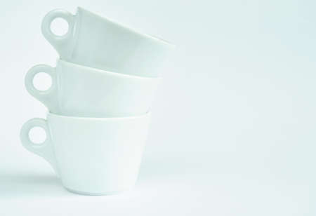 Three white coffee cups on a white backgroundの写真素材