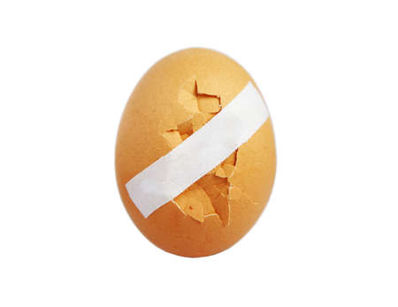 Cracked egg pasted with a aid for breakfast on a white backgroundの写真素材