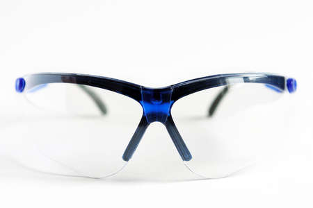 Protective goggles in blue frames on a white background. Eye protection during work