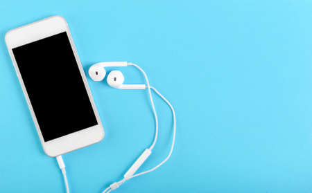 smartphone and headphones business concept blue backgroundの写真素材