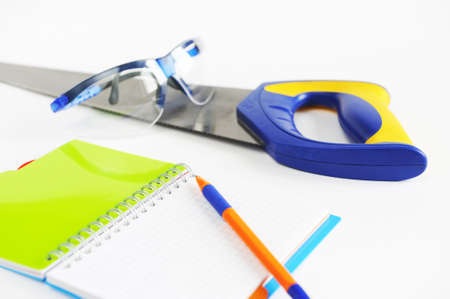 Composition of construction tools and a notepad for writing
