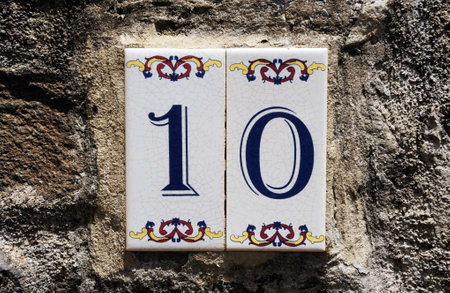 Vintage Number 10. Street number plate with number 10 closeup on a white background.