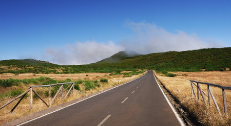 Asphalt car road and clouds on blue sky in summer dayの写真素材
