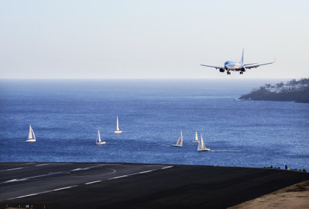 TUI Boeing 737. The Commercial jet aeroplane started the landing gear system for landing .. Airport Funchal, Madeira, Portugal. Atlantic Ocean. August 12, 2018.のeditorial素材