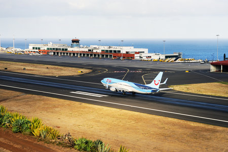 TUI Boeing 737. The Commercial jet aeroplane started the landing gear system for landing .. Airport Funchal, Madeira, Portugal. Atlantic Ocean. August 12, 2018.のeditorial素材