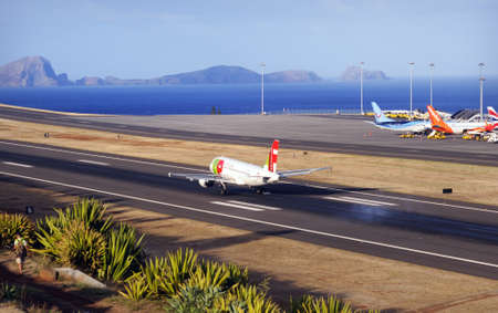TUI Boeing 737. The Commercial jet aeroplane started the landing gear system for landing .. Airport Funchal, Madeira, Portugal. Atlantic Ocean. August 12, 2018.のeditorial素材
